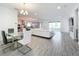 Open concept dining area with glass table and modern chandelier at 4408 Renly Ln, Clermont, FL 34711