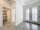 Bright foyer with wood-look tile floor and view of bathroom at 4408 Renly Ln, Clermont, FL 34711
