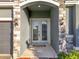 Elegant double front doors with arched entryway and stone accents at 4408 Renly Ln, Clermont, FL 34711