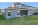 Two-story house with covered patio and grassy yard at 4408 Renly Ln, Clermont, FL 34711