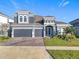 Two-story house with three-car garage and stone accents at 4408 Renly Ln, Clermont, FL 34711