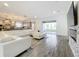 Spacious living area with sectional sofa, fireplace, and kitchen access at 4408 Renly Ln, Clermont, FL 34711