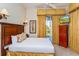 Bedroom with a king-size bed, dresser, and access to a balcony at 7513 Excitement Dr, Reunion, FL 34747