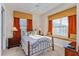 Bright bedroom with a comfortable bed and window seat at 7513 Excitement Dr, Reunion, FL 34747