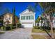 Beautiful two-story home with a white garage door and lush landscaping at 7513 Excitement Dr, Reunion, FL 34747