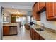 Kitchen with granite countertops, stainless steel appliances, and open layout at 7513 Excitement Dr, Reunion, FL 34747
