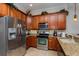 Well-equipped kitchen, featuring stainless steel appliances and wood cabinets at 7513 Excitement Dr, Reunion, FL 34747