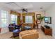 Comfortable living room with leather armchairs and a large flat-screen TV at 7513 Excitement Dr, Reunion, FL 34747