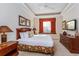 Spacious main bedroom with a king-size bed and a window seat at 7513 Excitement Dr, Reunion, FL 34747