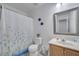 Clean bathroom with shower, toilet, vanity, and decorative accents at 7606 Acklins Rd, Kissimmee, FL 34747