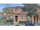 Two-story townhome with terracotta tile roof and light orange exterior at 7606 Acklins Rd, Kissimmee, FL 34747