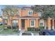 Attractive two-story townhome with dark brown front door and landscaping at 7606 Acklins Rd, Kissimmee, FL 34747