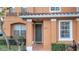 Front entrance of a two-story townhouse with a green door at 7606 Acklins Rd, Kissimmee, FL 34747