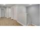 Upstairs hallway with wood-look flooring and access to bedrooms and bathroom at 7606 Acklins Rd, Kissimmee, FL 34747