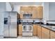 Updated kitchen, featuring stainless steel appliances and wood cabinets at 7606 Acklins Rd, Kissimmee, FL 34747