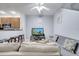 Living room with gray couches, a flat-screen TV, and a ceiling fan at 7606 Acklins Rd, Kissimmee, FL 34747