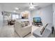 Spacious living room featuring comfortable seating and a view into the kitchen at 7606 Acklins Rd, Kissimmee, FL 34747