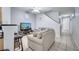 Living room with gray couches, a flat-screen TV, and a ceiling fan at 7606 Acklins Rd, Kissimmee, FL 34747