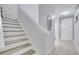 Modern staircase with wood and white risers leading to the second floor at 7606 Acklins Rd, Kissimmee, FL 34747