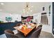 Bright and airy dining room with a four-seater table and stylish chandelier at 8891 Geneve Ct, Kissimmee, FL 34747
