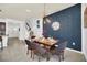 Modern dining room featuring a four-seater wooden table and stylish decor at 8891 Geneve Ct, Kissimmee, FL 34747