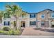 Inviting two-story townhome with brick walkway and landscaping at 8891 Geneve Ct, Kissimmee, FL 34747
