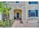Townhome entry with covered porch and brick walkway at 8891 Geneve Ct, Kissimmee, FL 34747