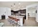 Open kitchen with island seating and views to living area at 8891 Geneve Ct, Kissimmee, FL 34747