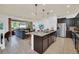 Open concept kitchen with island and views to living room at 8891 Geneve Ct, Kissimmee, FL 34747