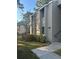 Exterior view of condo building, showing landscaping and building number 107 at 107 Springwood Cir # A, Longwood, FL 32750