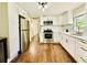Modern kitchen with white cabinets and stainless steel appliances at 110 Oleander Ave, Auburndale, FL 33823
