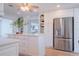 Bright kitchen with white cabinets, island, and stainless steel appliances at 136 Reef Rd, South Daytona, FL 32119
