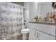 Bathroom with seashell shower curtain and granite vanity at 1917 Michigan Drive, Poinciana, FL 34759