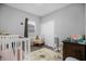 Bedroom with a crib, rocking chair, and plenty of storage at 1917 Michigan Drive, Poinciana, FL 34759