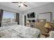 Spacious bedroom with a queen bed, TV, and dresser at 1917 Michigan Drive, Poinciana, FL 34759