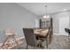 Dining room with wooden table, brown chairs, and chandelier at 1917 Michigan Drive, Poinciana, FL 34759