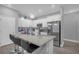 Modern kitchen with white cabinets, granite counters, and island at 1917 Michigan Drive, Poinciana, FL 34759