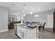 Kitchen island and dining area with white cabinets and granite at 1917 Michigan Drive, Poinciana, FL 34759