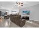Open living room and kitchen with tile floors and brown couches at 1917 Michigan Drive, Poinciana, FL 34759