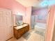Bathroom with double vanity, shower, and separate tub at 210 Watling Way # 24-210, Davenport, FL 33897