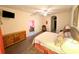 Spacious Primary bedroom with large bed, dresser, and access to a private balcony at 210 Watling Way # 24-210, Davenport, FL 33897