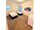 Bedroom featuring two twin beds, a dresser, and whimsical wall decor at 210 Watling Way # 24-210, Davenport, FL 33897