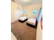 Two twin beds in a bright guest bedroom with neutral decor and carpet at 210 Watling Way # 24-210, Davenport, FL 33897