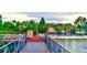 Boardwalk path leads to a community dock with lake access, beach area, and covered seating at 210 Watling Way # 24-210, Davenport, FL 33897