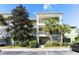 Two-story building with green exterior, balconies, and palm trees at 210 Watling Way # 24-210, Davenport, FL 33897