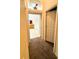 Hallway with carpet flooring, leading to the bathroom at 210 Watling Way # 24-210, Davenport, FL 33897