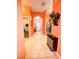 Hallway with peach walls and tile flooring at 210 Watling Way # 24-210, Davenport, FL 33897