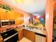 Kitchen with stainless steel appliances and a breakfast bar at 210 Watling Way # 24-210, Davenport, FL 33897