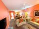 Living room with floral couches and a view of the dining area at 210 Watling Way # 24-210, Davenport, FL 33897