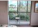 Sliding glass doors open to a scenic balcony overlooking a lake at 210 Watling Way # 24-210, Davenport, FL 33897